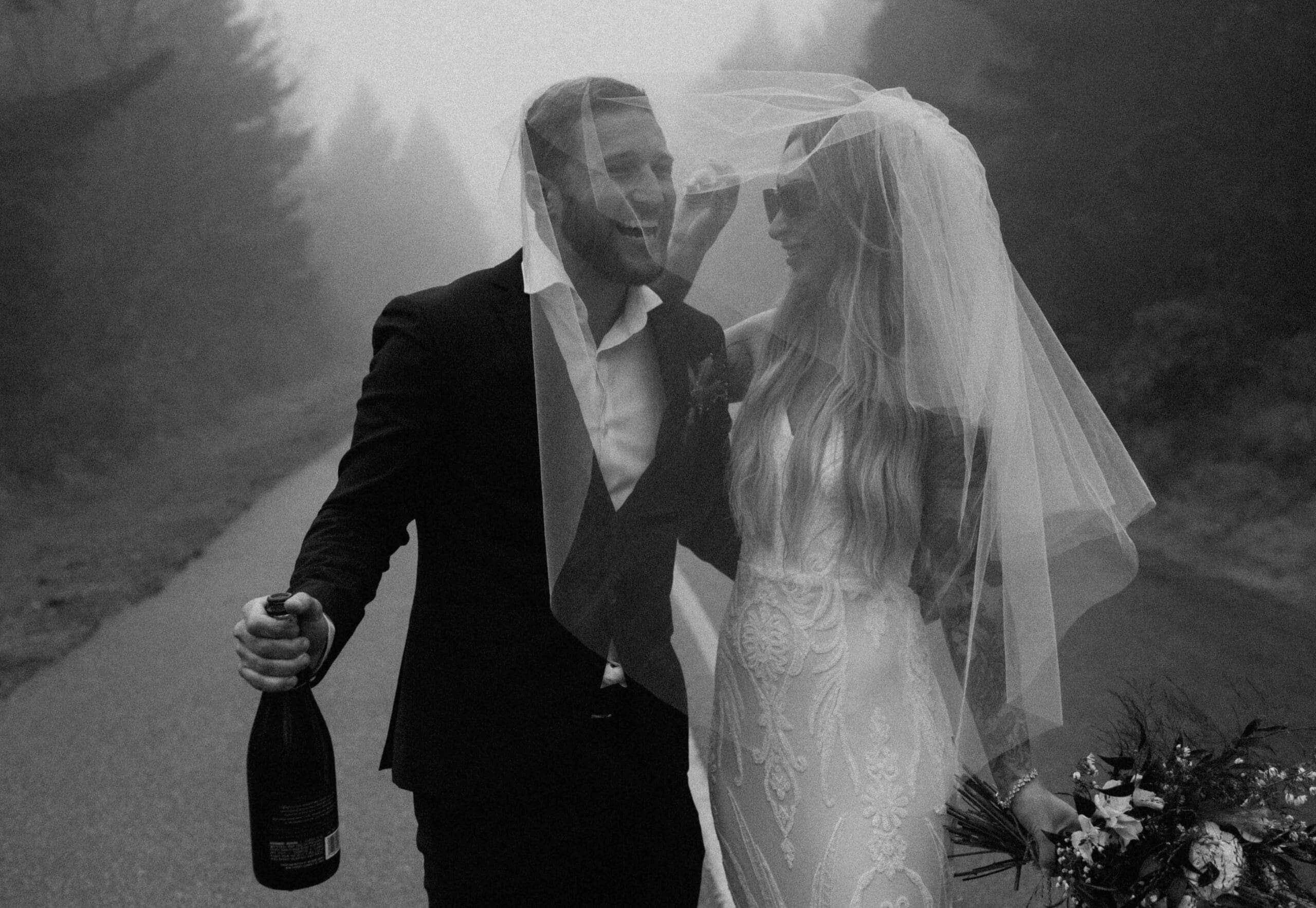 elope couple celebrating under a bridal veil while walking around the blue ridge mountains