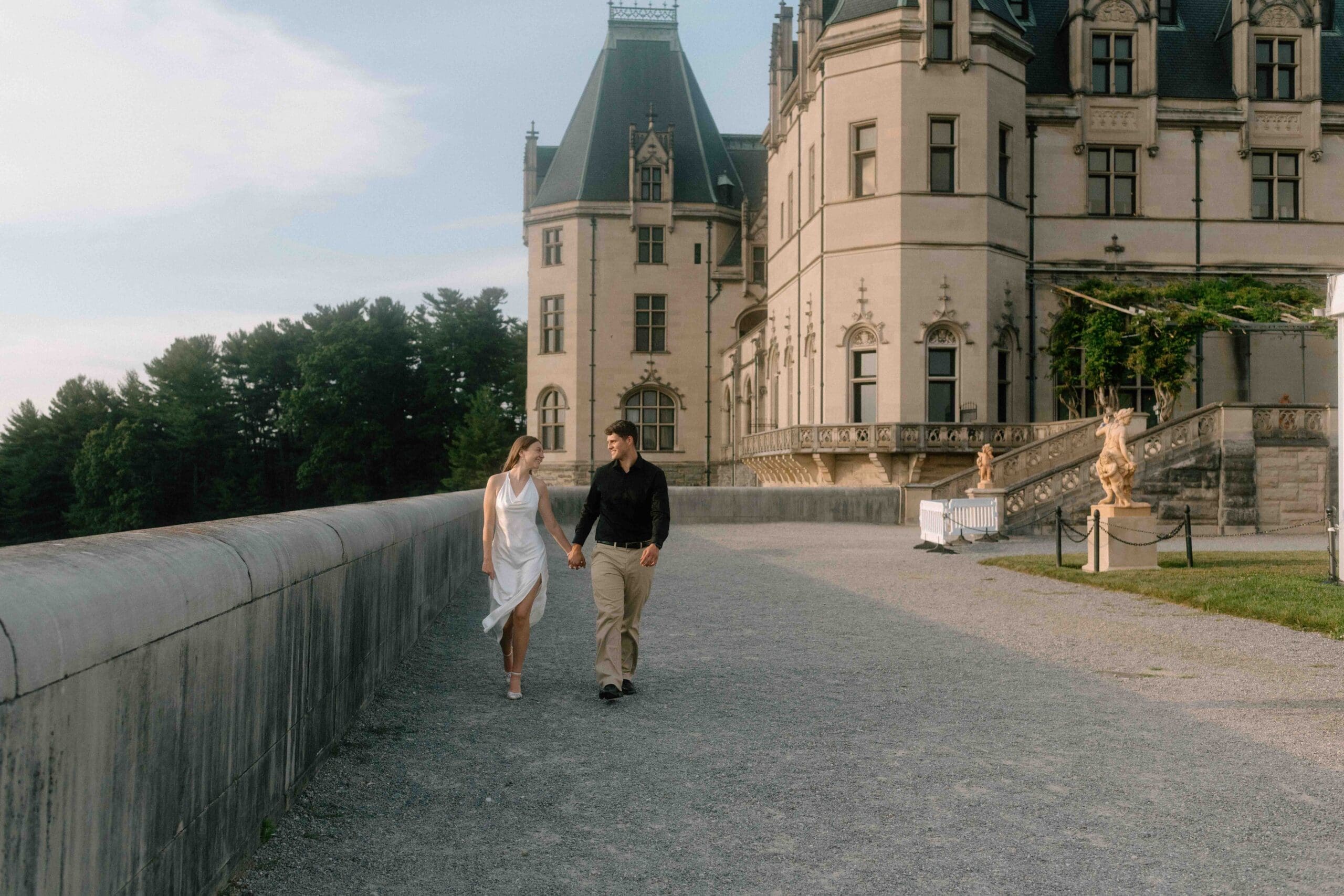 engaged couple waking at the biltmore estate courtyard in asheville north carolina