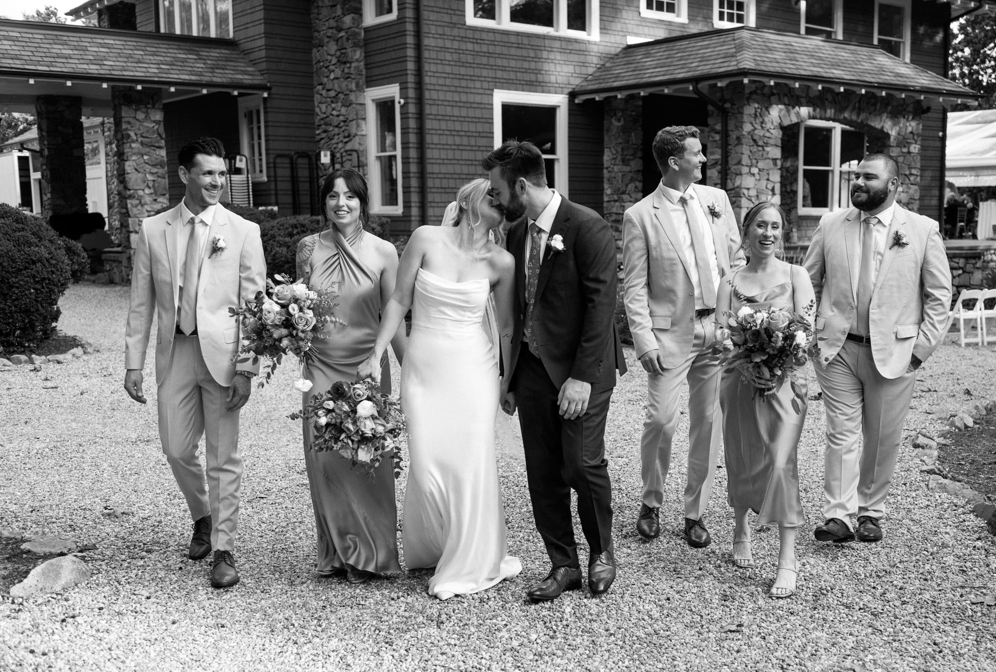 bridal party having fun while walking together outside vanlandingham estate in charlotte north carolina