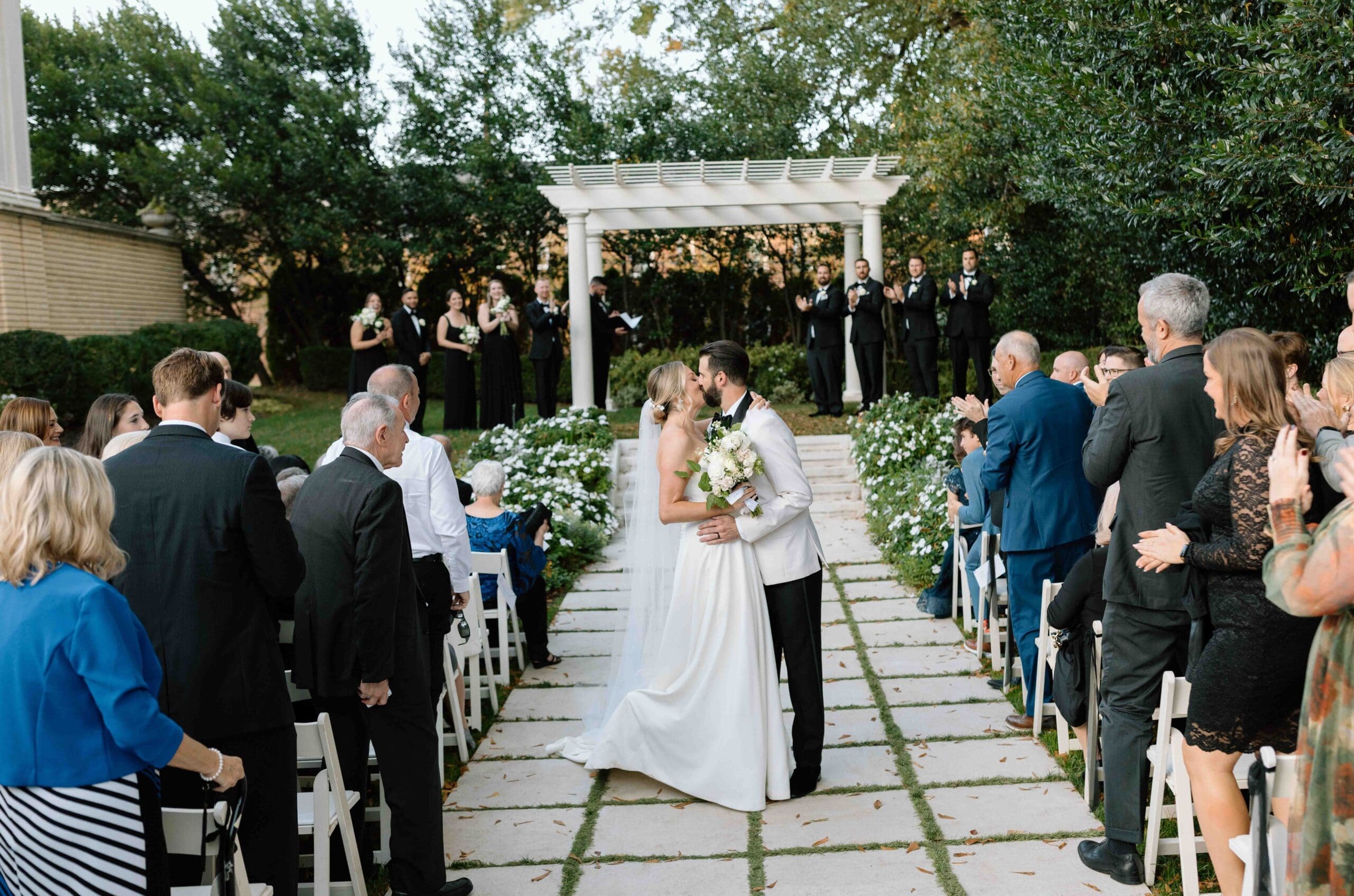bride and groom dip kiss at their ceremony exit in separk mansion charlotte north carolina